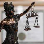 Woman statue holding scales of justice
